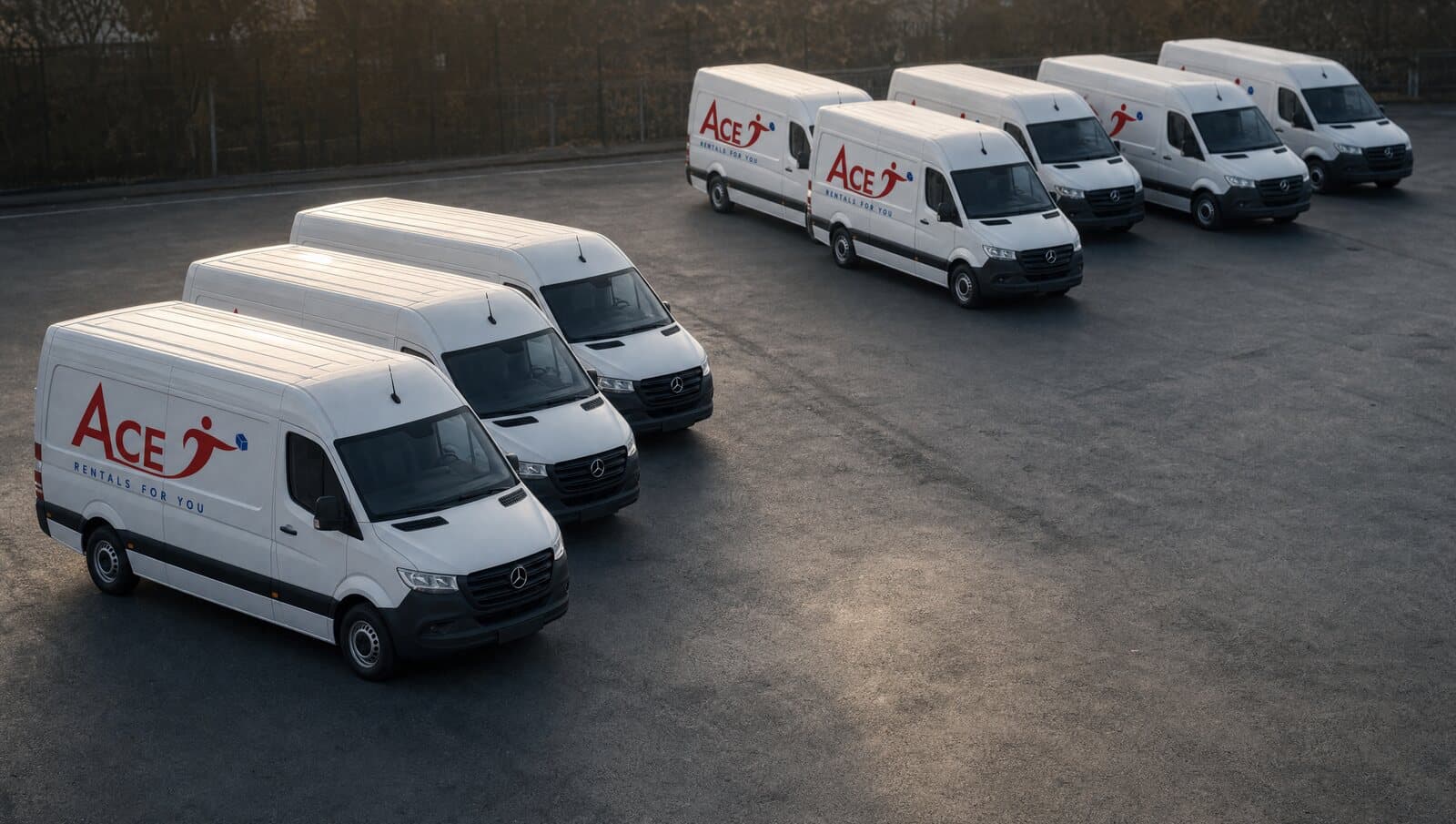 Delivery vans parked in a line at a logistics depot